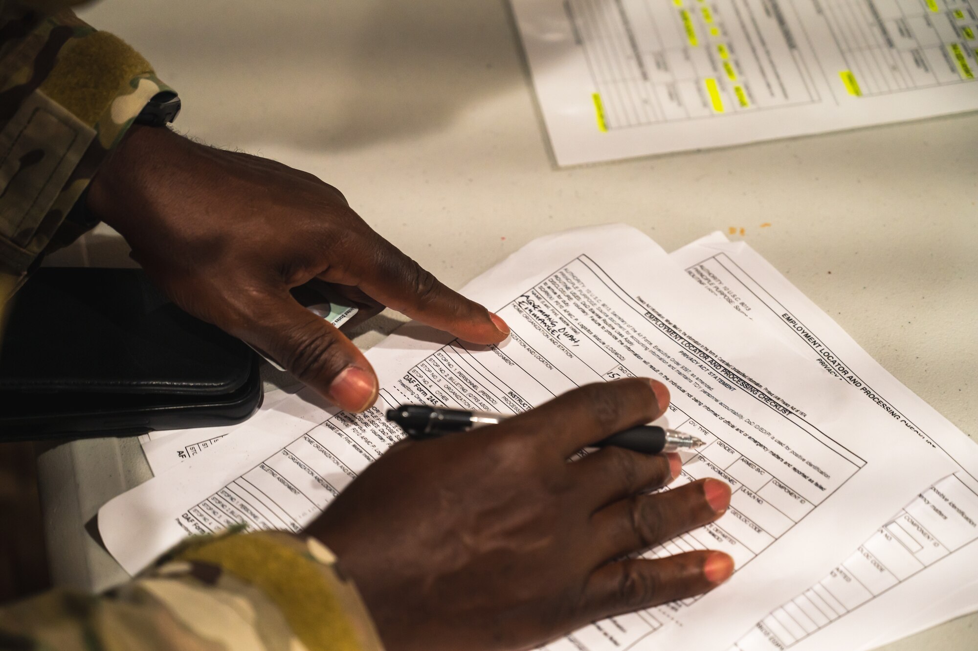 U.S. Air Force Staff Sgt. Emmanuel Agyemang Duah, 8th Comptroller Squadron financial analysis supervisor, fills out paperwork at the base theater during exercise Beverly Sentinel 24-2 at Kunsan Air Base