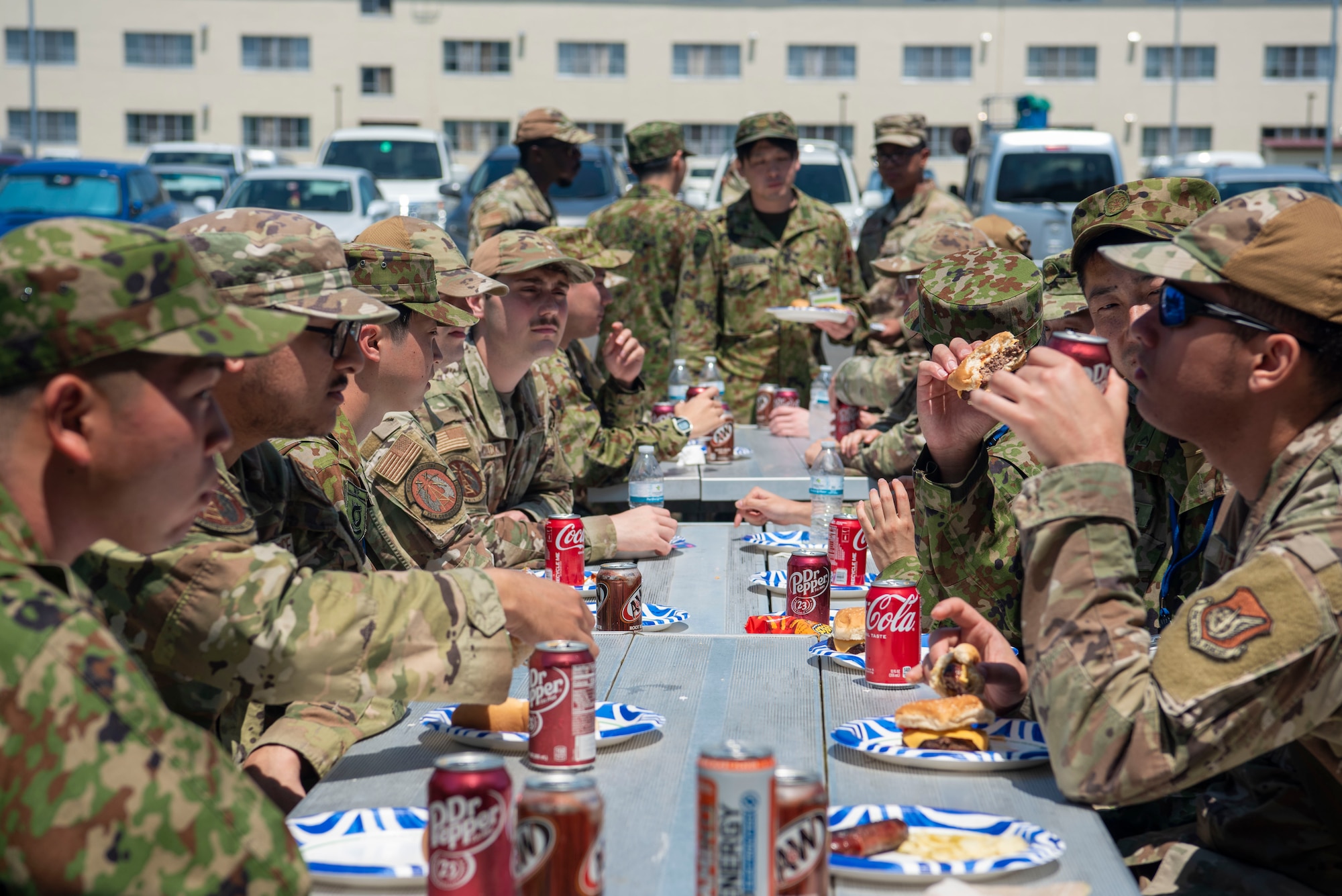 Japan Ground Self-Defense Force soldiers eat lunch with U.S. Air Force Airmen assigned to the 35th Communications Squadron during a JGSDF Basic English Training Course tour at Misawa Air Base, Japan, July 18, 2024.