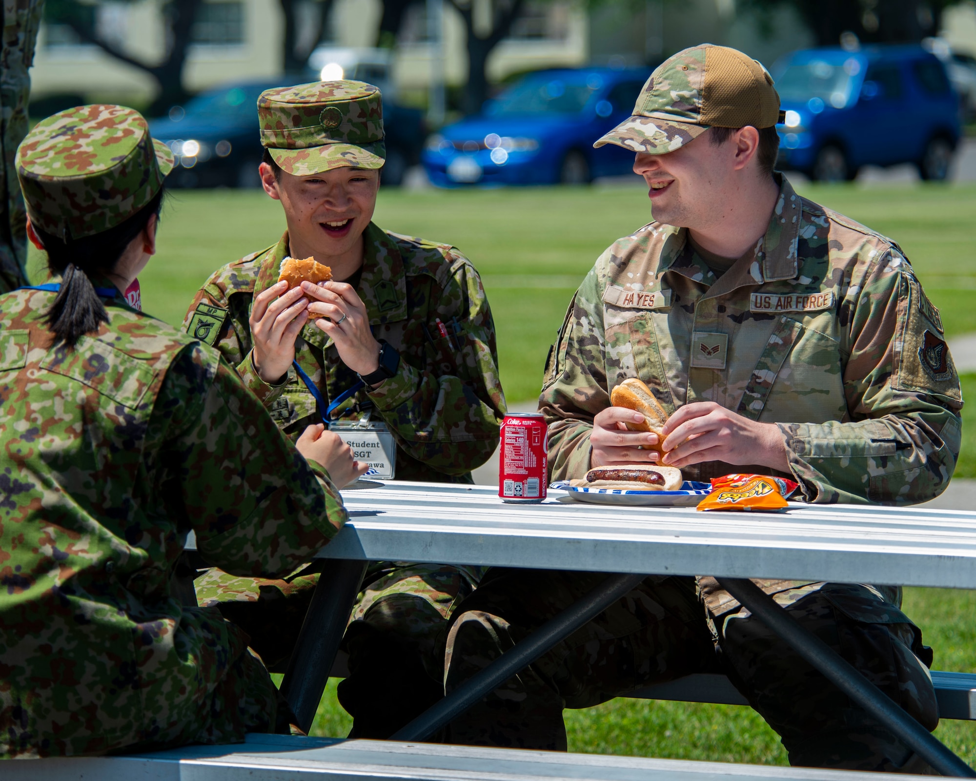 Japan Ground Self-Defense Force Sgt. Daimu Shinagawa, left, Basic English Training course student, talks with U.S. Air Force Senior Airman Ryley Hayes, 35th Communications Squadron client systems operations technician, during a JGSDF Basic English Training Course tour at Misawa Air Base, Japan, July 18, 2024.