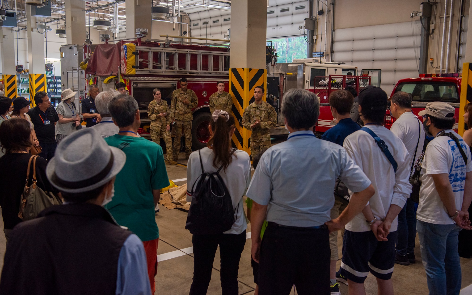 U.S. Air Force Airman 1st Class Malik Williams, center, 35th Civil Engineer Squadron firefighter, talks about the mission and equipment of a base fire department during a Misawa Friendship Tour at Misawa Air Base, Japan, July 19, 2024.