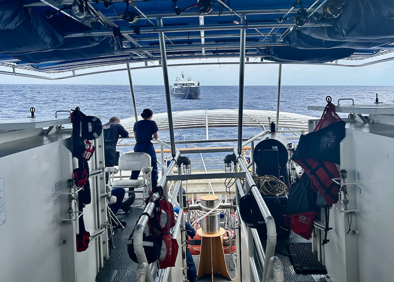 The USCGC Oliver Henry (WPC 1140) crew tow the 150-foot 497-ton motor yacht Black Pearl 1, located approximately 200 nautical miles west of the Republic of Palau, on July 21, 2024, after responding to a distress call. The 11-person yacht crew, who reported a locked rudder and flooding in the bilge, was assisted by Oliver Henry's crew with dewatering and damage control as they headed toward Palau in 25 mph winds and 4 to 6-foot seas. (U.S. Coast Guard photo by Petty Officer 3rd Class Ryder Nolan)