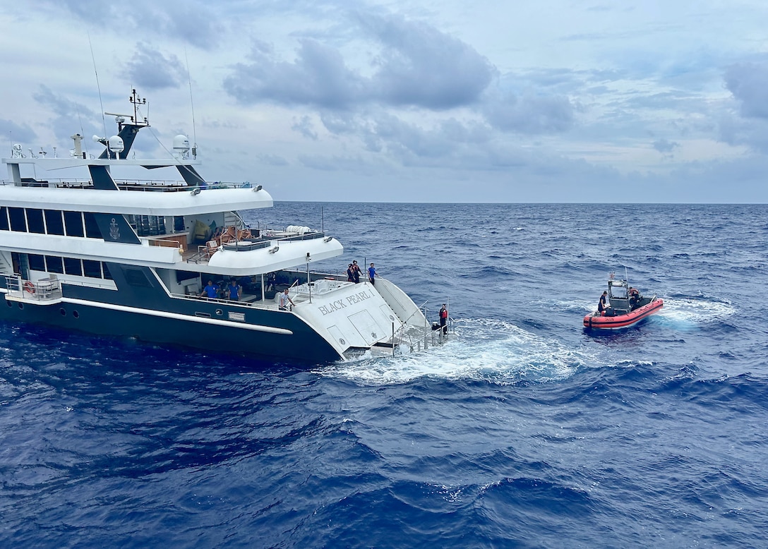 A rescue and assistance team from the USCGC Oliver Henry (WPC 1140) approaches the 150-foot 497-ton motor yacht Black Pearl 1, located approximately 200 nautical miles west of the Republic of Palau, on July 21, 2024, after responding to a distress call. The 11-person yacht crew, who reported a locked rudder and flooding in the bilge, was assisted by Oliver Henry's crew with dewatering and damage control. They were then towed toward Palau by the Oliver Henry in 25 mph winds and 4 to 6-foot seas. (U.S. Coast Guard photo by Petty Officer 3rd Class Ryder Nolan)