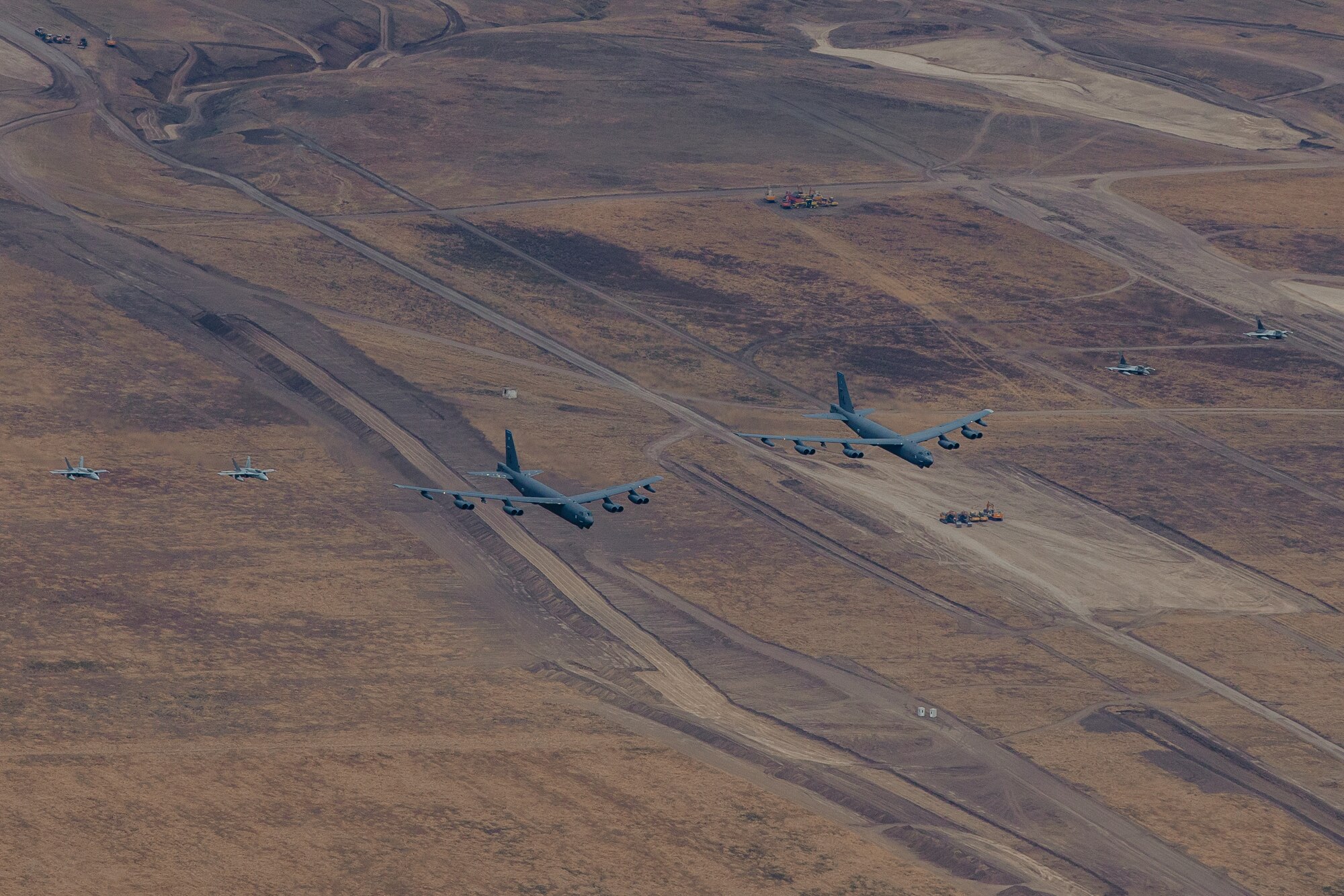 A pair of B-52H Stratofortresses from Barksdale Air Force Base, La., fly in formation alongside Romanian and Finnish fighter jets as part of Bomber Task Force deployment 24-4, July 21, 2024. BTF 24-4 underpins the NATO alliance’s collective deterrence and commitment to defending the Euro-Atlantic region from hostile actions. (Courtesy Photo)