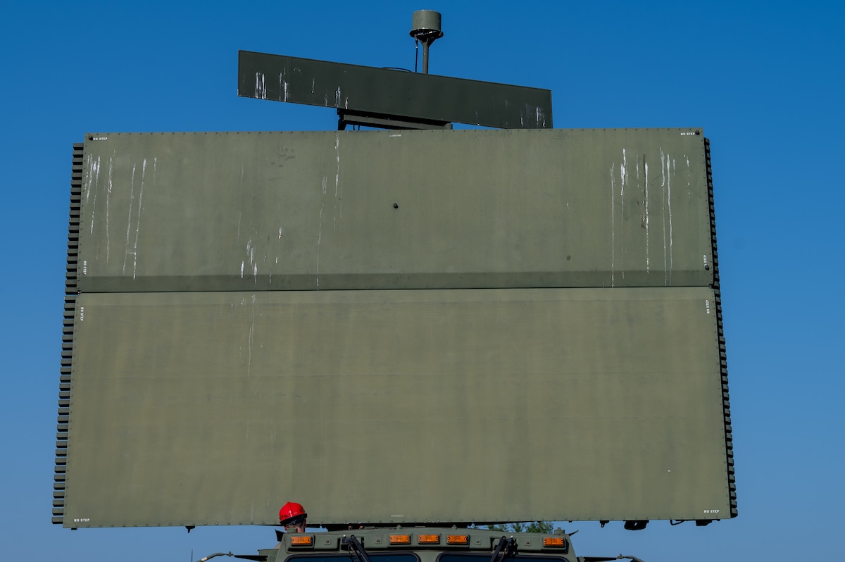 An Airman sets up a satellite.