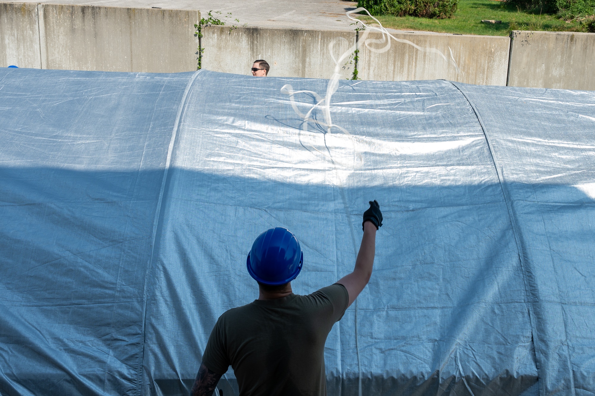 An Airman tosses a line to his wingman.