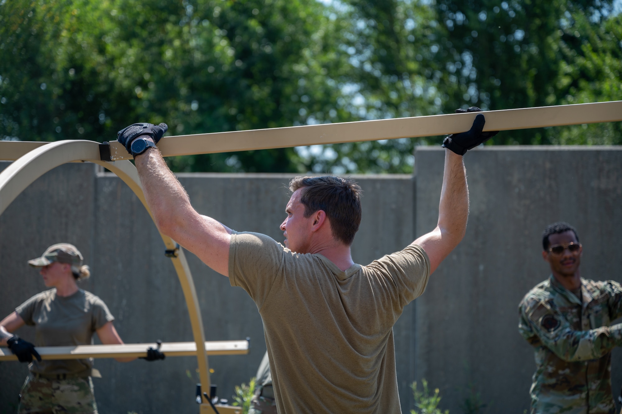 An Airman helps set up a tent.