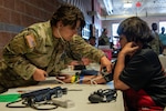 U.S. Army Spc. Brianna Bottorff, a combat medic assigned to the 215th Medical Company, Indiana Army National Guard, triages a patient at the Blackfeet tribal Health - Operation Walking Shield Innovative Readiness Training medical mission at Browning High School in Browning, Mont., July 17, 2024.