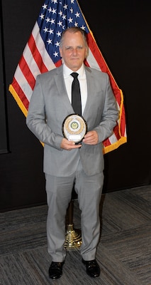 Donald Zuvich, a computer scientist for Naval Information Warfare Center Atlantic (NIWC), poses with his Excellence in Service Award from the New Orleans Federal Executive Board (FEB) following an award ceremony June 13 at the U.S. Department of the Interior Bureau of Safety and Environmental Enforcement New Orleans Office. Zuvich was named Mentor of the Year for his contributions to the NIWC Atlantic mentoring program.