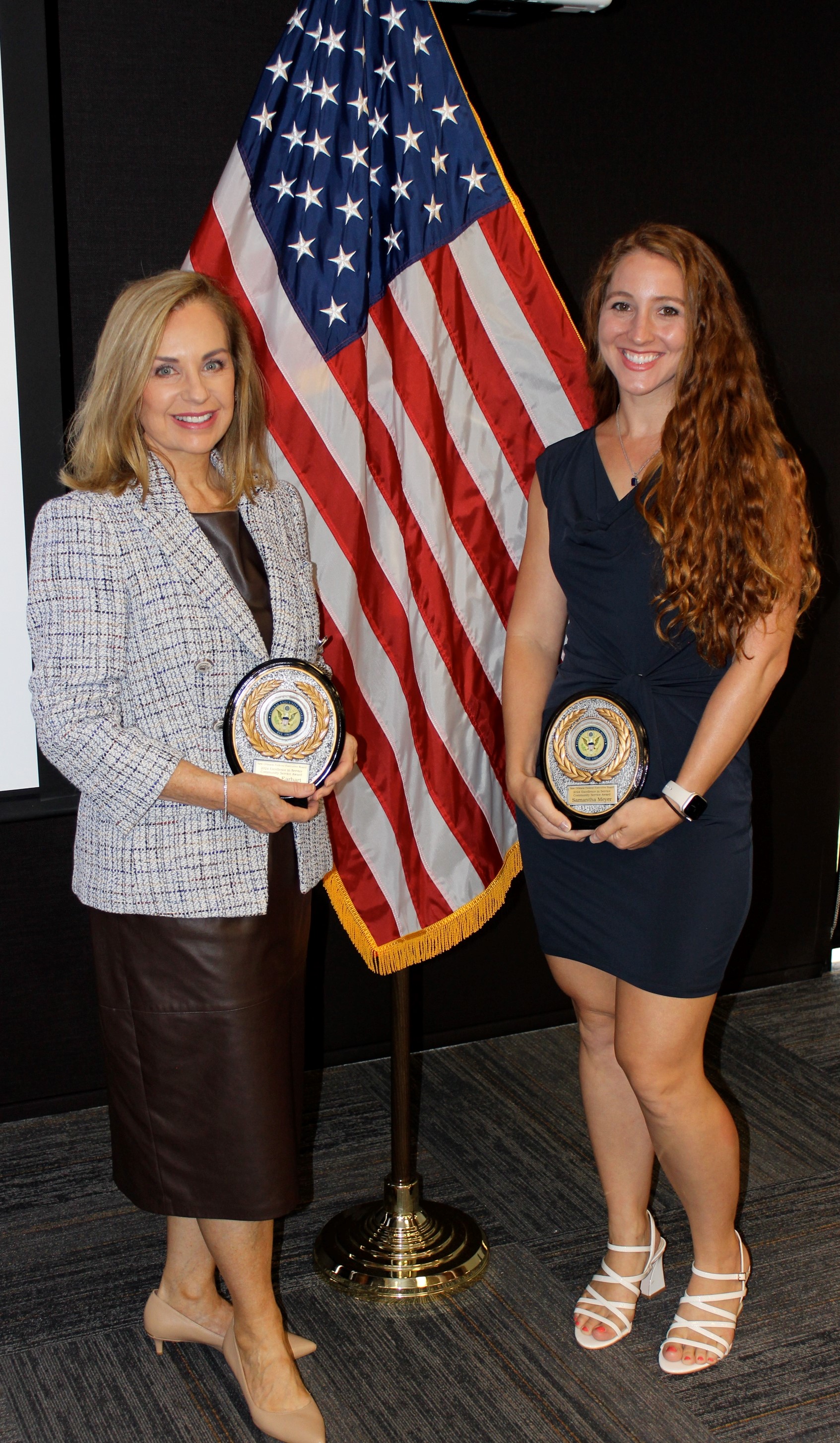 Naval Information Warfare Center (NIWC) Atlantic Information Technology (IT) Specialist Melissa Earhart, left, and Scientist Samantha Meyer pose with their Excellence in Service Awards from the New Orleans (NOLA) Federal Executive Board (FEB) following an award ceremony June 13 at the U.S. Department of the Interior Bureau of Safety and Environmental Enforcement NOLA Office. Earhart and Meyer, co-leads for the NIWC Atlantic NOLA detachment STEM program, won the Community Service Team Award for STEM.