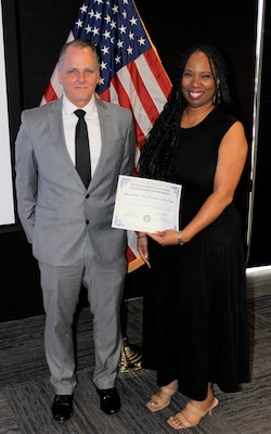 Naval Information Warfare Center (NIWC) Atlantic Computer Scientists Donald Zuvich and Monica Weber, pose with their Excellence in Service Award from the New Orleans (NOLA) Federal Executive Board (FEB) following an award ceremony June 13 at the U.S. Department of the Interior Bureau of Safety and Environmental Enforcement NOLA Office. Zuvich and Weber represented the Navy Personnel and Pay (NP2) Team, who received an Honorable Mention for Team Excellence.