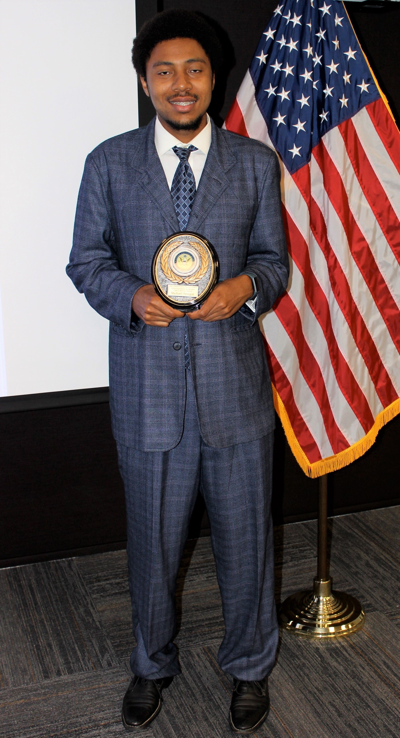 Michael Sinegar, a software developer for Naval Information Warfare Center Atlantic, poses with his Excellence in Service Award from the New Orleans Federal Executive Board (FEB) following an award ceremony June 13 at the U.S. Department of the Interior Bureau of Safety and Environmental Enforcement New Orleans Office. Sinegar won in the Call to Service category.