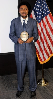 Michael Sinegar, a software developer for Naval Information Warfare Center Atlantic, poses with his Excellence in Service Award from the New Orleans Federal Executive Board (FEB) following an award ceremony June 13 at the U.S. Department of the Interior Bureau of Safety and Environmental Enforcement New Orleans Office. Sinegar won in the Call to Service category.