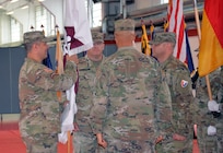 Col. Marc Welde, commander of U.S. Army Medical Logistics Command, prepares to pass the U.S. Army Medical Materiel Center-Europe colors to Col. Chad Vermillion, signifying his confidence in him as the next USAMMC-E commander during a change of... (Holger Koelsch)