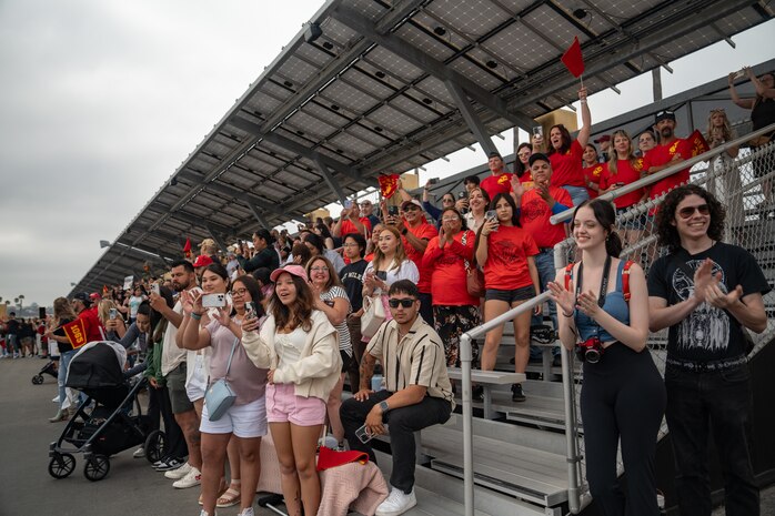 Friends and family of Delta Company, 1st Recruit Training Battalion, cheer on their new U.S. Marines during a motivational run at Marine Corps Recruit Depot San Diego, California, July 18, 2024. The company motivational run is a three-mile cadence run conducted around the Depot and is the last physical training event the Marines will conduct before they graduate from MCRD San Diego. The event is also the first time friends and families will see their newly transformed Marines. (U.S. Marine Corps photo by Lance Cpl. Francisco Angel)