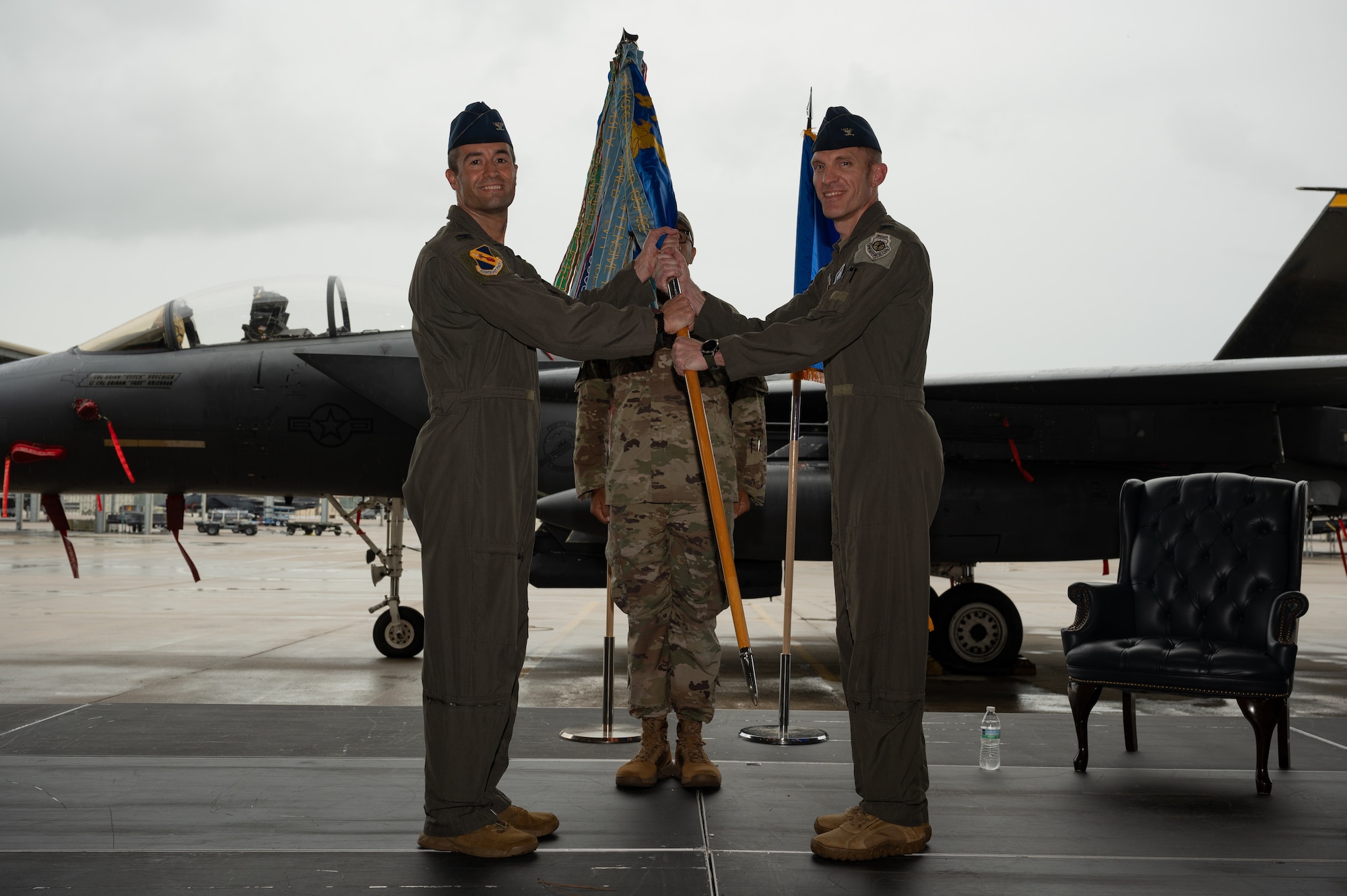 U.S. Air Force Col. Brian Novchich, 4th Operations Group incoming commander, right, takes the guidon from Col. Morgan Lohse, 4th Fighter Wing commander, during an assumption of command ceremony at Seymour Johnson Air Force Base, North Carolina, July 12, 2024. During an Air Force change of command ceremonies, the passing of the guidon from the higher headquarters commander to the incoming unit commander represents the new commander’s assumption of their position. (U.S. Air Force photo by Senior Airman Rebecca Sirimarco-Lang)