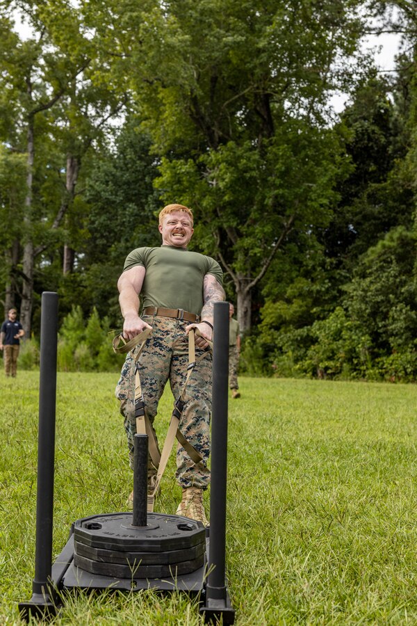 A U.S. Marine with 2nd Marine Logistics Group drags a weighted sled during the Fittest of the 2nd MLG event hosted by the 2nd MLG Human Performance Center on Camp Lejeune, North Carolina, July 19, 2024. Teams from across 2nd MLG regiments and battalions competed for the title of “Fittest of 2nd MLG” in order to promote physical fitness, camaraderie, and friendly competition. (U.S. Marine Corps photo by Lance Cpl. Christian Salazar)