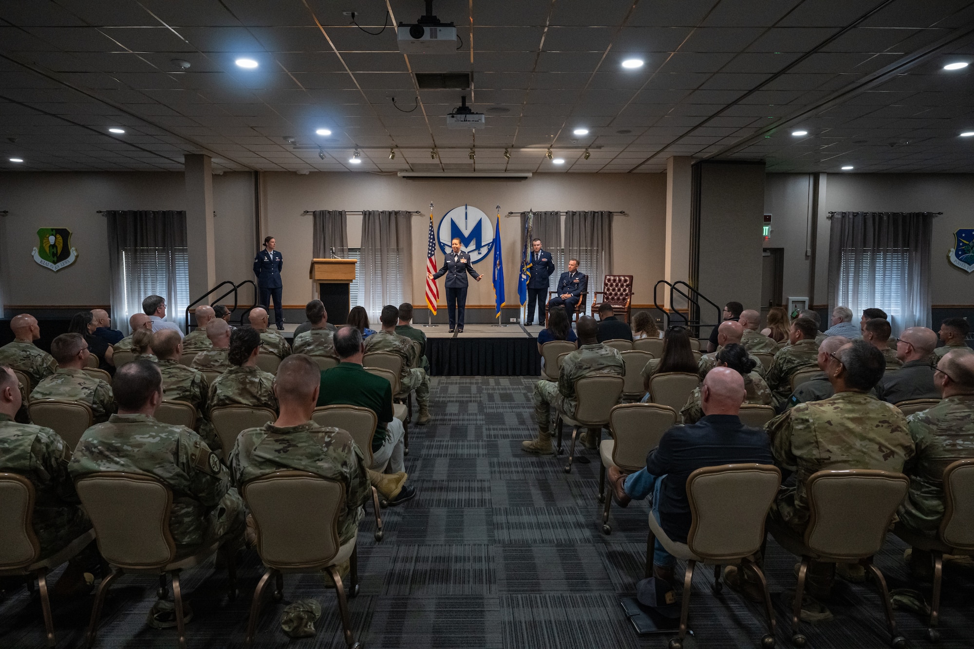 U.S. Air Force Chief Master Sgt. Becky Thomas, 91st Missile Wing command chief (center), speaks to the crowd at an assumption of responsibility ceremony at Minot Air Force Base, North Dakota, July 19, 2024. Thomas spoke about her excitement and enthusiasm for the opportunity to lead the 91st Missile Wing’s Airmen. (U.S. Air Force photo by Senior Airman Kyle Wilson)