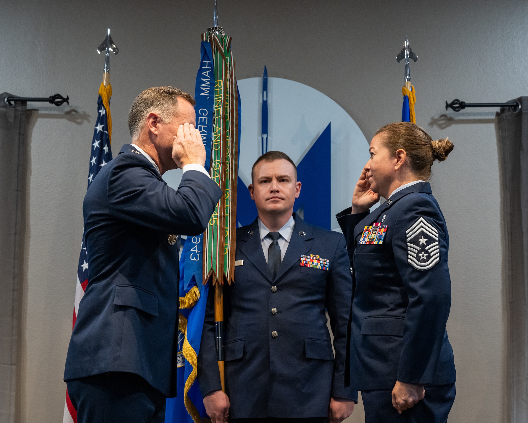 U.S. Air Force Chief Master Sgt. Becky Thomas, 91st Missile Wing command chief (right), salutes U.S. Air Force Col. James Schlabach, 91st Missile Wing commander (left), during an assumption of responsibility ceremony at Minot Air Force Base, North Dakota, July 19, 2024. In her role as command chief of the 91st Missile Wing, Thomas will serve as the primary advisor to Schlabach on matters relating to the readiness, professional development, welfare, discipline and quality of life for Airmen assigned to the 91st Missile Wing. (U.S. Air Force photo by Senior Airman Kyle Wilson)