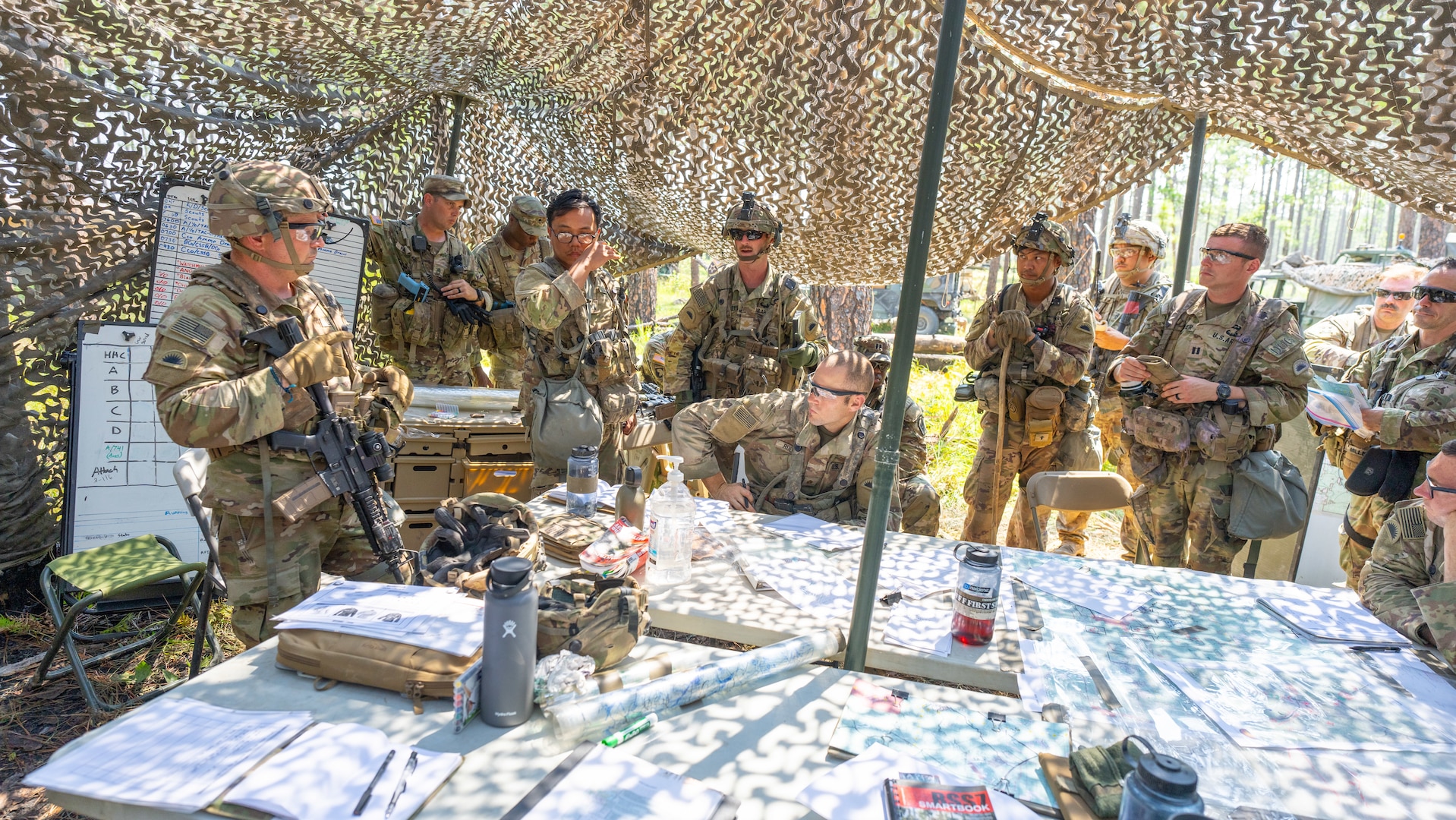 Lt. Col. Joshua Rapp, commander of Task Force Guardian, conducts an after-action review with his staff July 21, 2024, at Fort Johnson, La. The review follows Task Force Guardian's first night of engagement with opposition forces during the Joint Readiness Training Center rotation, preparing the 41st Infantry Brigade Combat Team for upcoming overseas missions.