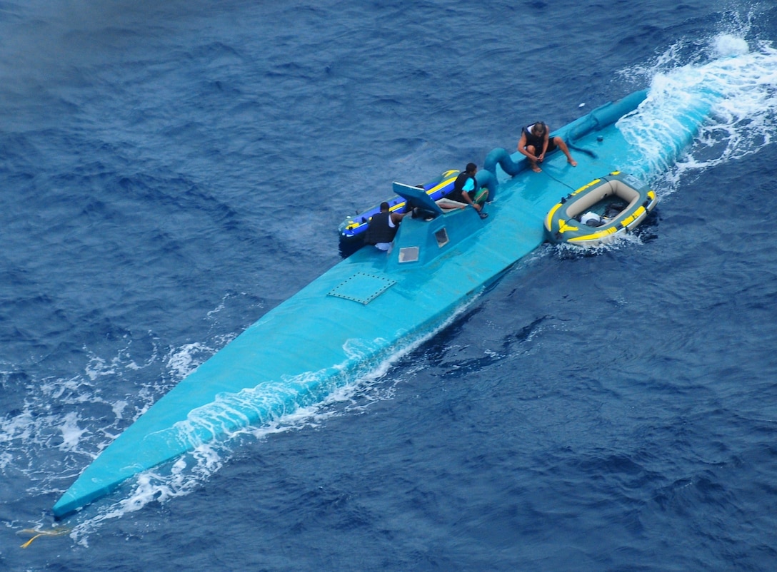 The crew of a semi-submersible drug trafficking vessel prepares to abandon their boat before being intercepted and detained by the Coast Guard approximately 150 miles northwest of the Colombian-Ecuador border Jan. 8, 2009.