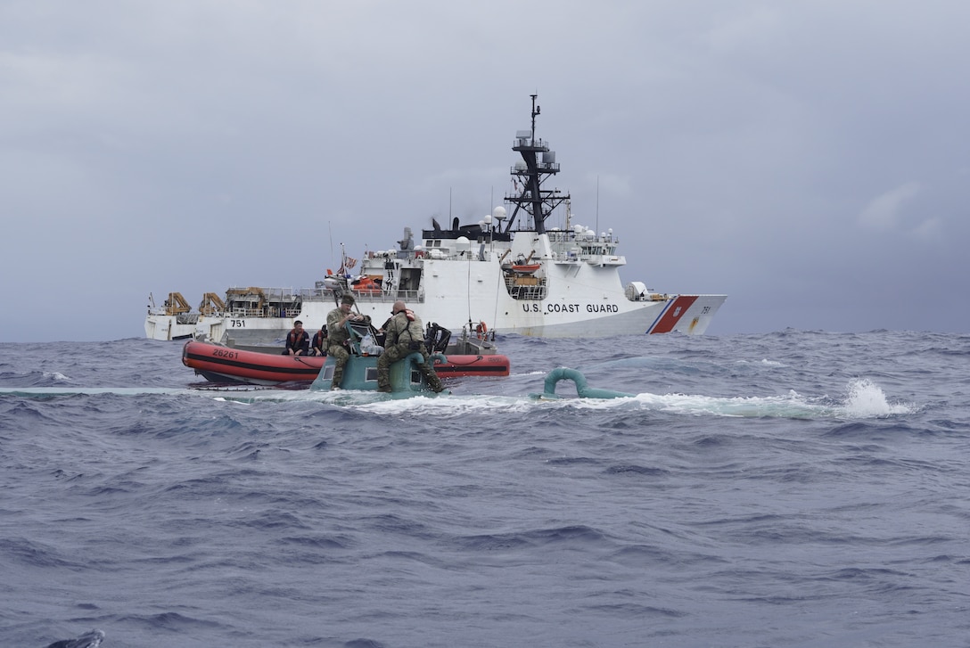 Members of the Coast Guard Cutter Waesche (WMSL-751) law enforcement boarding team inspect a self-propelled semi-submersible (SPSS) in international waters of the Eastern Pacific Ocean, Nov. 20, 2023.