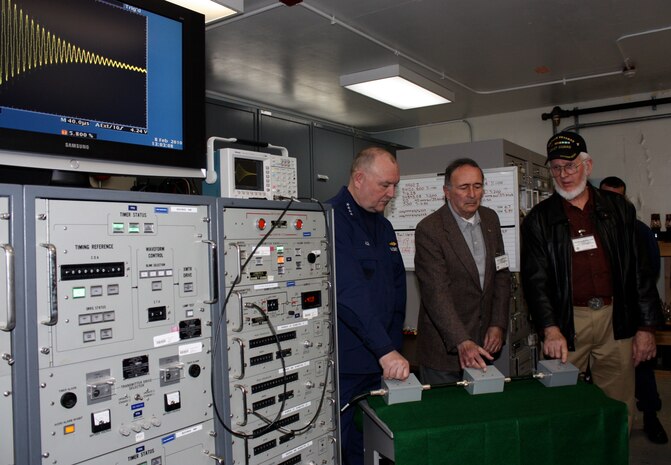 Coast Guard Commandant Adm. Thad Allen, George Hamilton, and Jack Anastasia (l to r) turn off switches on attenuator boxes to decrease the Long-Range Aids to Navigation (LORAN-C) signal at LORAN Support Unit Wildwood, Feb. 8.