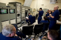 Crewmembers of Coast Guard Loran Station Middletown, previous station officers in charge, the Coast Guard Auxiliary and civilian Coast Guard employees await the termination of the broadcasted domestic Loran-C signal Feb. 8, 2010.