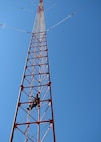 A loran tower supervisor from Civil Engineering Unit Oakland begins climbing the 600-foot Coast Guard loran tower to conduct routine maintenance Sept. 18, 2008. The loran station crew ceased broadcasting of their domestic signal at noon, Feb. 8, 2010, as part of a nationwide termination of the North American Long Range Navigation-C signal.