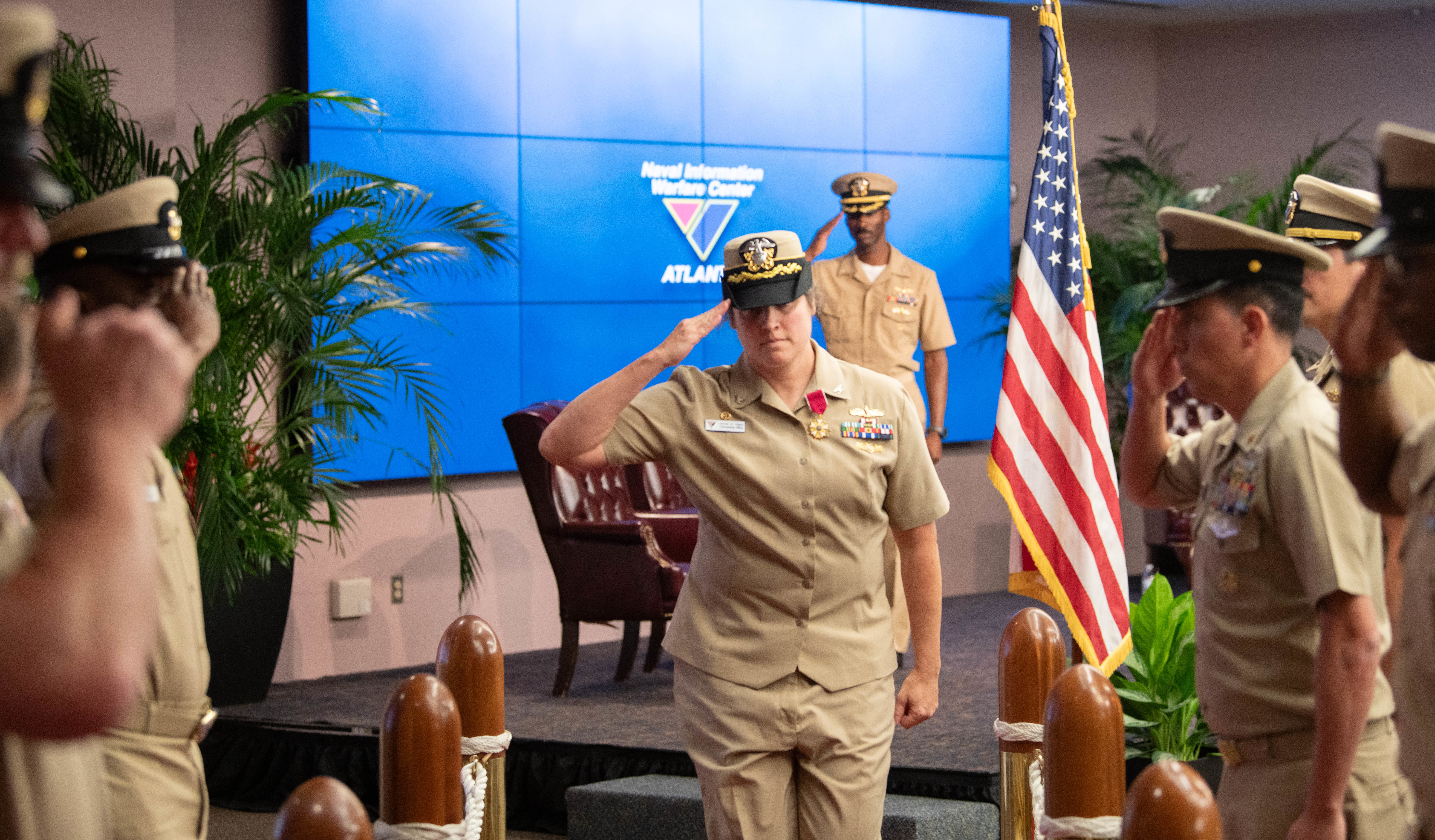 .S. Navy Capt. Nicole Nigro, Naval Information Warfare Center (NIWC) Atlantic outgoing commanding officer, salutes sideboys during a change of command ceremony at Joint Base Charleston, South Carolina, July 18, 2024. Nigro was relieved of command by Capt. Matthew O’Neal during the ceremony.