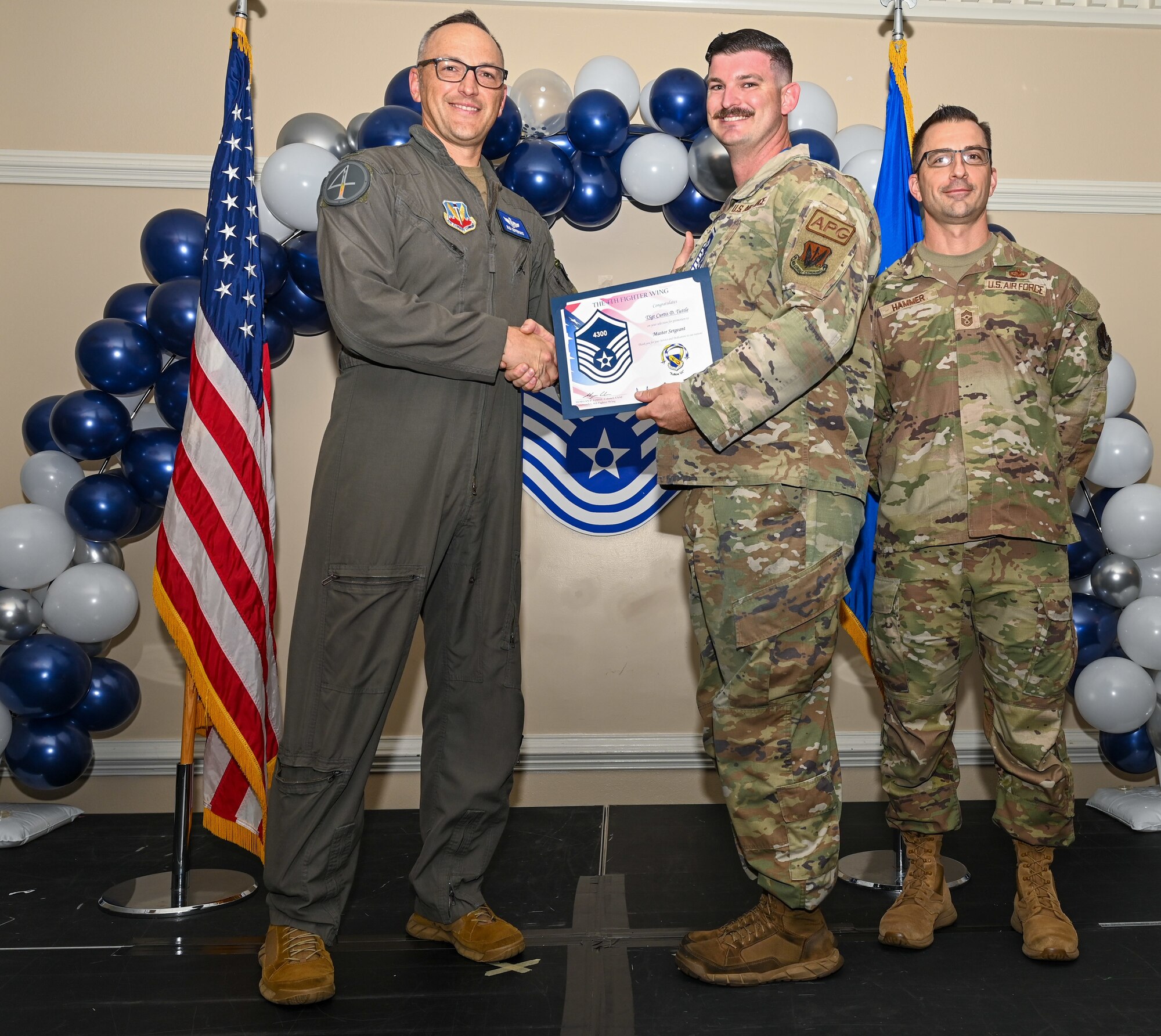 U.S. Air Force Col. Steven Bofferding, 4th Fighter Wing deputy commander (left), and Chief Master Sgt. Paul Hammer, 4 FW command chief, present a certificate to Master Sgt. select Curtis Tuttle (center), 334th Fighter Generation Squadron equipment custodian, during a Master Sergeant Release Ceremony at Seymour Johnson Air Force Base, North Carolina, June 6, 2024. A total of 5,500 Airmen were promoted among a pool of 29,497 across the Air Force.  (U.S. Air Force photo by Airman Rebecca Tierney)