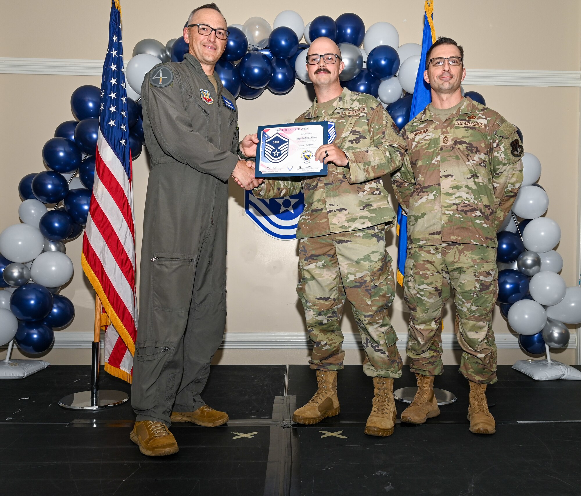 U.S. Air Force Col. Steven Bofferding, 4th Fighter Wing deputy commander (left), and Chief Master Sgt. Paul Hammer, 4 FW command chief, present a certificate to Master Sgt. select Tyler Dudley (center), 4th Security Forces Squadron flight chief, during a Master Sergeant Release Ceremony at Seymour Johnson Air Force Base, North Carolina, June 6, 2024. The ceremony recognized the selectee’s new accomplishment of senior non-commissioned officer. (U.S. Air Force photo by Airman Rebecca Tierney)