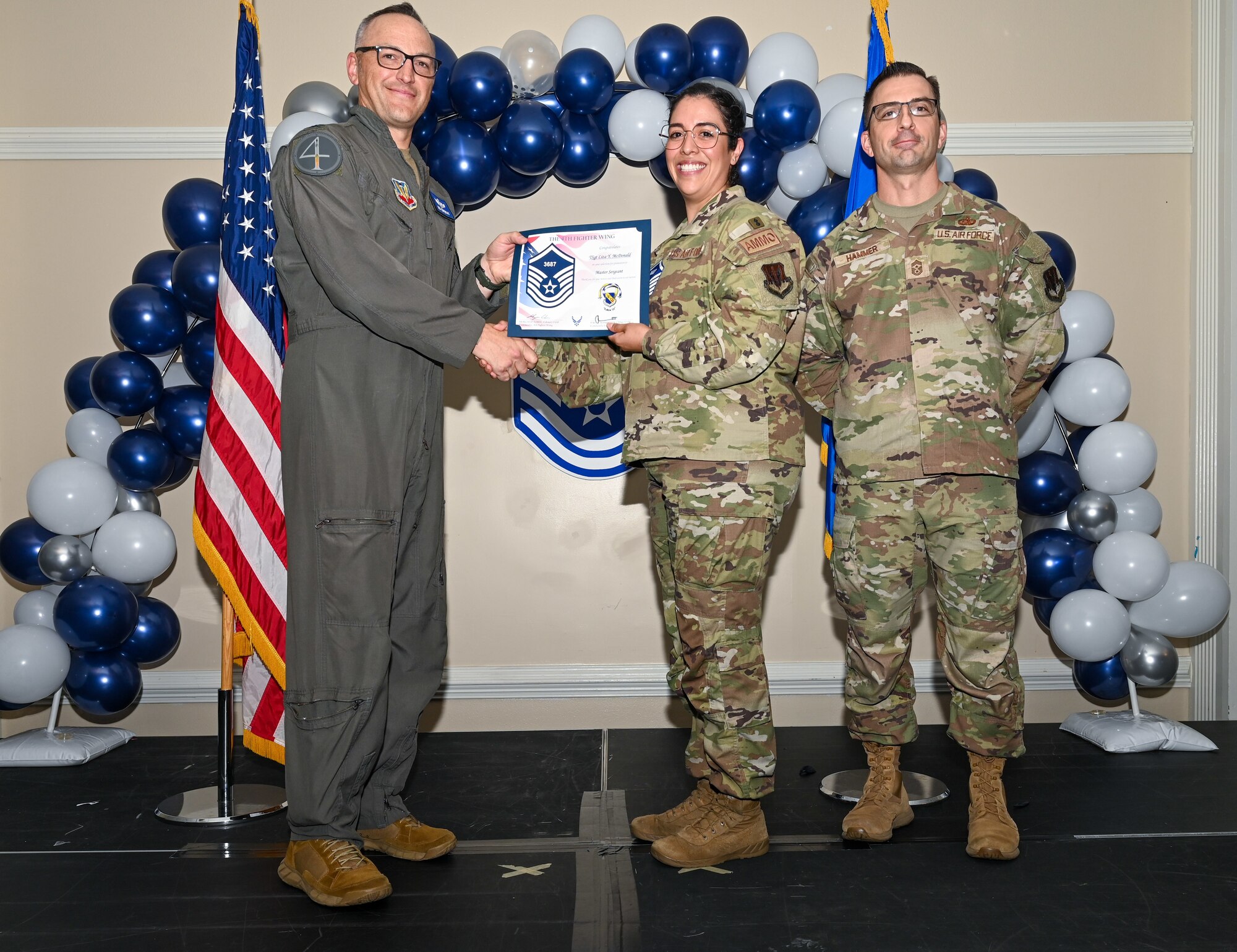 U.S. Air Force Col. Steven Bofferding, 4th Fighter Wing deputy commander (left), and Chief Master Sgt. Paul Hammer, 4 FW command chief, present a certificate to Master Sgt. select Tyler Dudley (center), 4th Security Forces Squadron flight chief, during a Master Sergeant Release Ceremony at Seymour Johnson Air Force Base, North Carolina, June 6, 2024. The ceremony recognized the selectee’s new accomplishment of senior non-commissioned officer. (U.S. Air Force photo by Airman Rebecca Tierney)