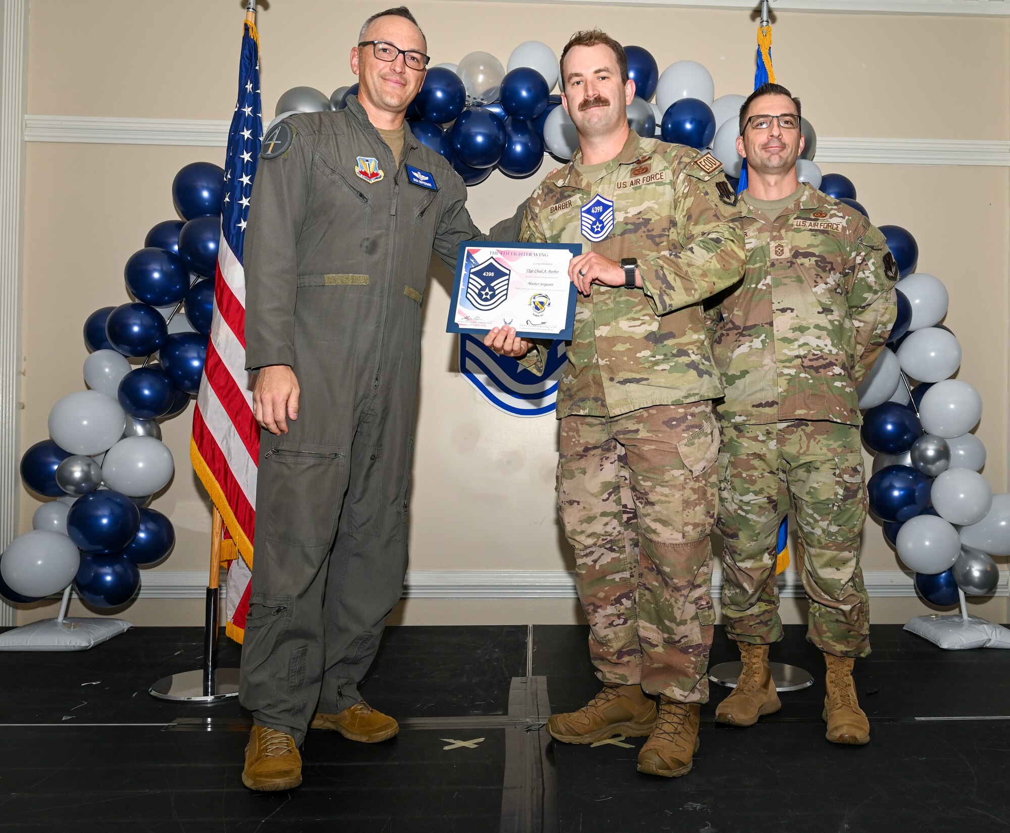 U.S. Air Force Col. Steven Bofferding, 4th Fighter Wing deputy commander (left), and Chief Master Sgt. Paul Hammer, 4 FW command chief, present a certificate to Master Sgt. select Tyler Dudley (center), 4th Security Forces Squadron flight chief, during a Master Sergeant Release Ceremony at Seymour Johnson Air Force Base, North Carolina, June 6, 2024. The ceremony recognized the selectee’s new accomplishment of senior non-commissioned officer. (U.S. Air Force photo by Airman Rebecca Tierney)