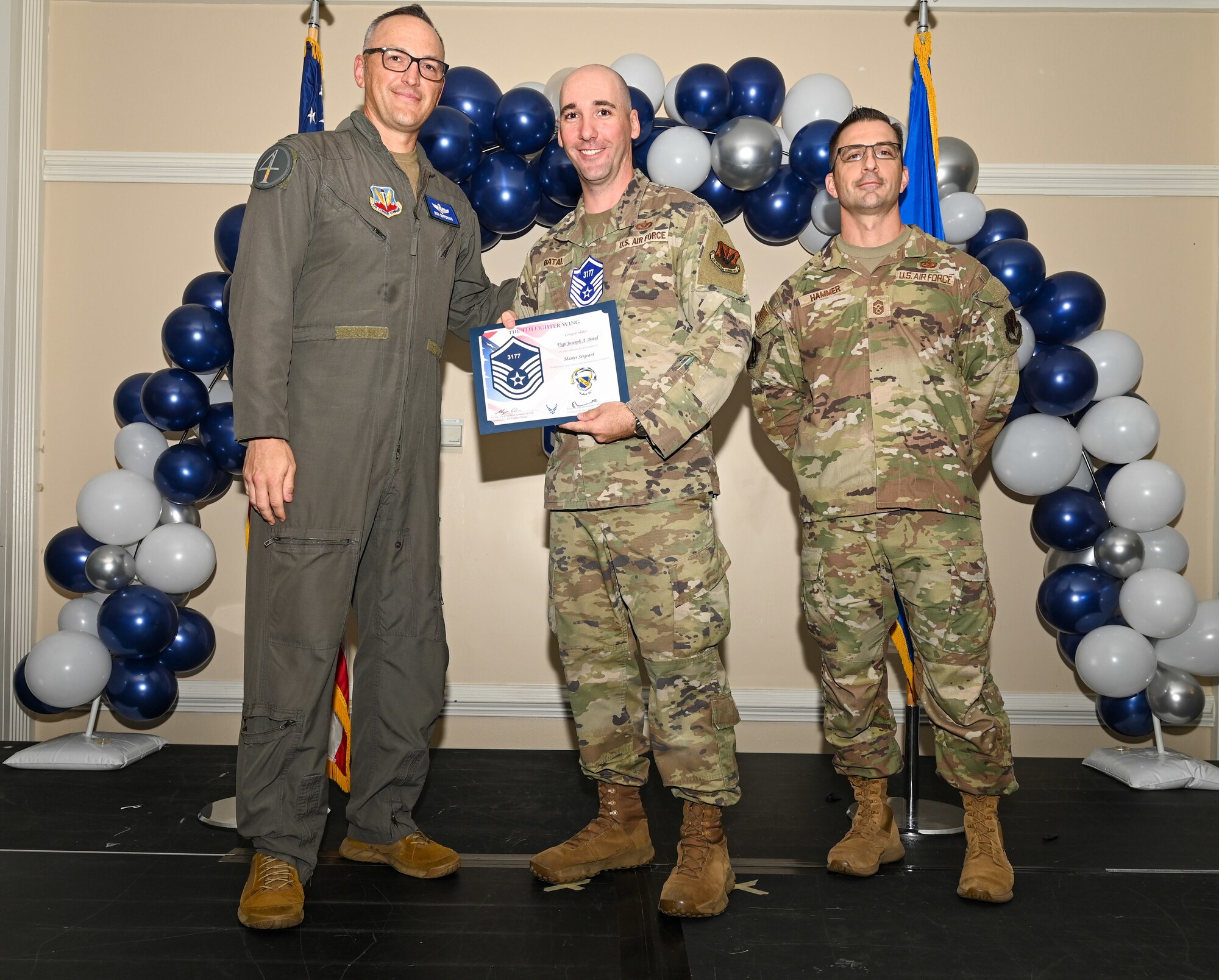 U.S. Air Force Col. Steven Bofferding, 4th Fighter Wing deputy commander (left), and Chief Master Sgt. Paul Hammer, 4 FW command chief, present a certificate to Master Sgt. select Tyler Dudley (center), 4th Security Forces Squadron flight chief, during a Master Sergeant Release Ceremony at Seymour Johnson Air Force Base, North Carolina, June 6, 2024. The ceremony recognized the selectee’s new accomplishment of senior non-commissioned officer. (U.S. Air Force photo by Airman Rebecca Tierney)