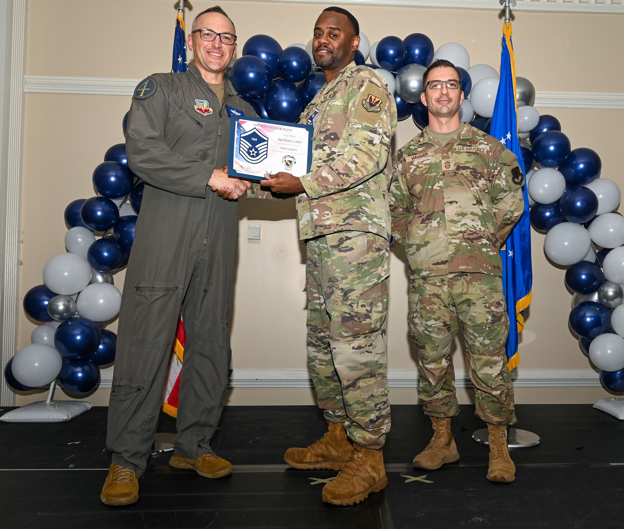 U.S. Air Force Col. Steven Bofferding, 4th Fighter Wing deputy commander (left), and Chief Master Sgt. Paul Hammer, 4 FW command chief, present a certificate to Master Sgt. select Tyler Dudley (center), 4th Security Forces Squadron flight chief, during a Master Sergeant Release Ceremony at Seymour Johnson Air Force Base, North Carolina, June 6, 2024. The ceremony recognized the selectee’s new accomplishment of senior non-commissioned officer. (U.S. Air Force photo by Airman Rebecca Tierney)