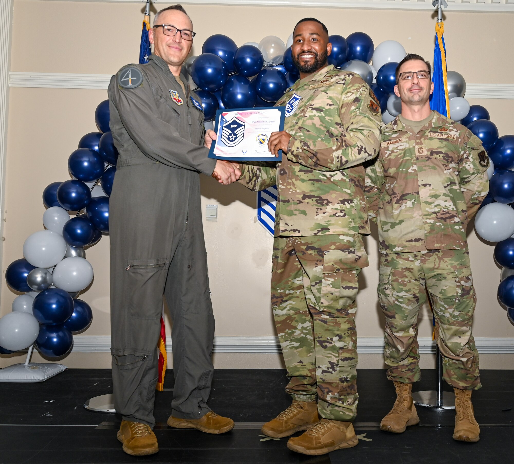 U.S. Air Force Col. Steven Bofferding, 4th Fighter Wing deputy commander (left), and Chief Master Sgt. Paul Hammer, 4 FW command chief, present a certificate to Master Sgt. select Tyler Dudley (center), 4th Security Forces Squadron flight chief, during a Master Sergeant Release Ceremony at Seymour Johnson Air Force Base, North Carolina, June 6, 2024. The ceremony recognized the selectee’s new accomplishment of senior non-commissioned officer. (U.S. Air Force photo by Airman Rebecca Tierney)