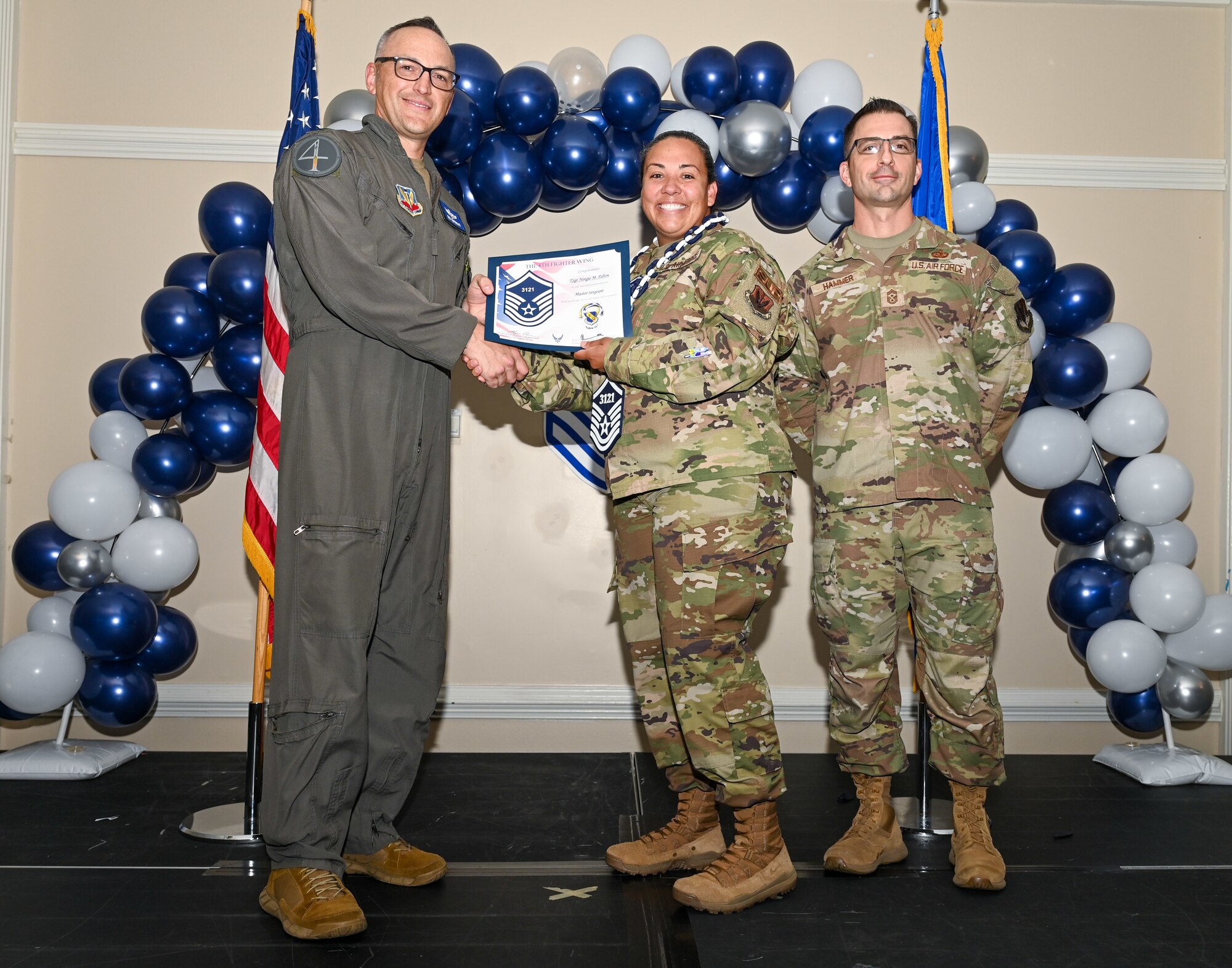 U.S. Air Force Col. Steven Bofferding, 4th Fighter Wing deputy commander (left), and Chief Master Sgt. Paul Hammer, 4 FW command chief, present a certificate to Master Sgt. select Tyler Dudley (center), 4th Security Forces Squadron flight chief, during a Master Sergeant Release Ceremony at Seymour Johnson Air Force Base, North Carolina, June 6, 2024. The ceremony recognized the selectee’s new accomplishment of senior non-commissioned officer. (U.S. Air Force photo by Airman Rebecca Tierney)