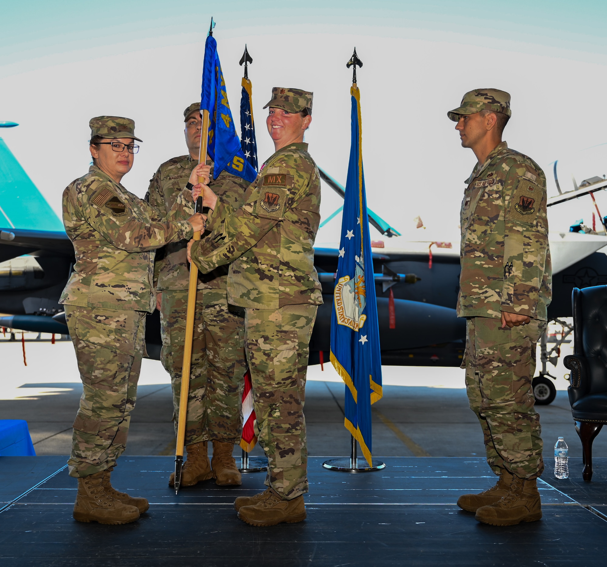 U.S. Air Force Col. Kathryn Roman, 4th Maintenance Group commander, relieves Maj. Amanda Miller of her duty as commander of the 334th Fighter Generation Squadron during a change of command ceremony at Seymour Johnson Air Force Base, June 21, 2024. The passing of the guidon is a tradition representing the change of commanders for the squadron. (U.S. Air Force photo by Airman Rebecca Tierney)