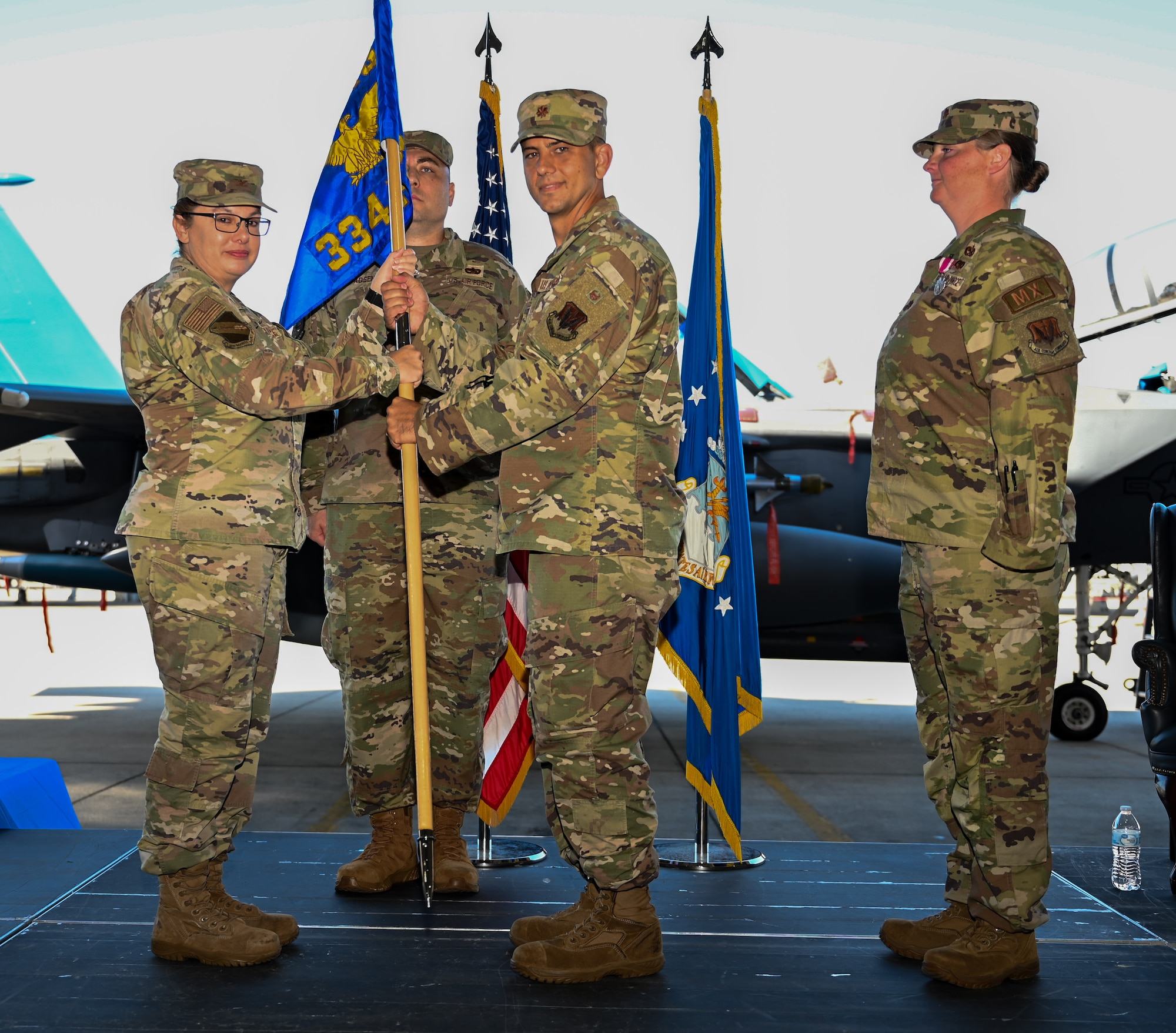 U.S. Air Force Col. Kathryn Roman, 4th Maintenance Group commander, appoints Maj. Michael Lundy as the new commander of the 334th Fighter Generation Squadron during a change of command ceremony at Seymour Johnson Air Force Base, June 21, 2024. The passing of the guidon is a tradition representing the change of commanders for the squadron. (U.S. Air Force photo by Airman Rebecca Tierney)