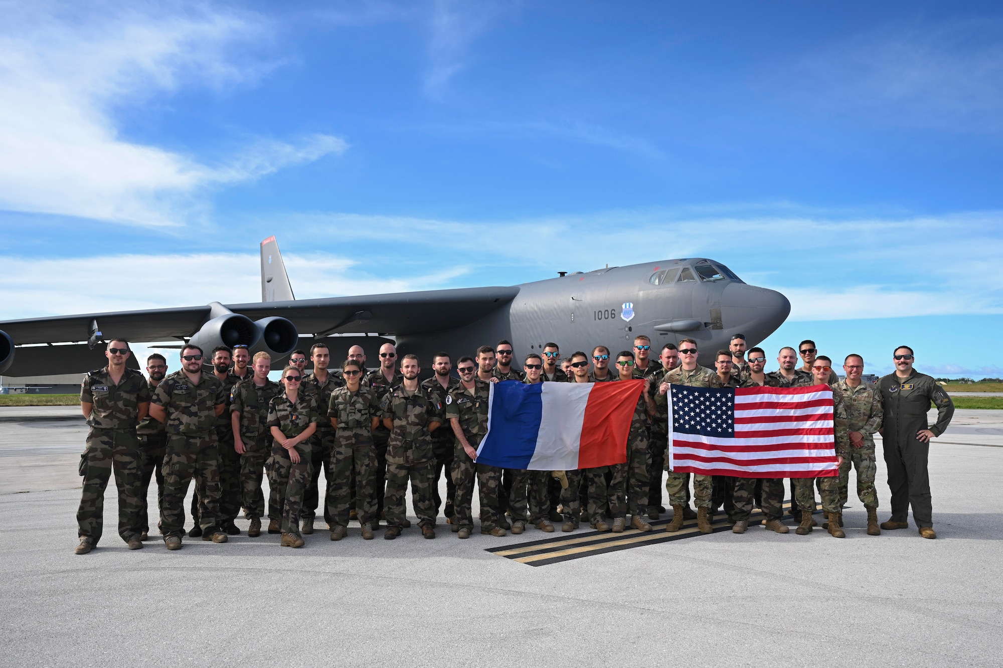 U.S. Airmen from the 20th Expeditionary Bomb Squadron and French Air Force members stand together after a joint exercise at Andersen Air Force Base, Guam, July 20, 2023. These exercises demonstrate the U.S. commitment to the region by building interoperability, multilateral cooperative arrangements alongside Allies and partners, advancing common interests and ensuring a free and open Indo-Pacific region. (U.S. Air Force photo by Airman 1st Class Nia Jacobs)