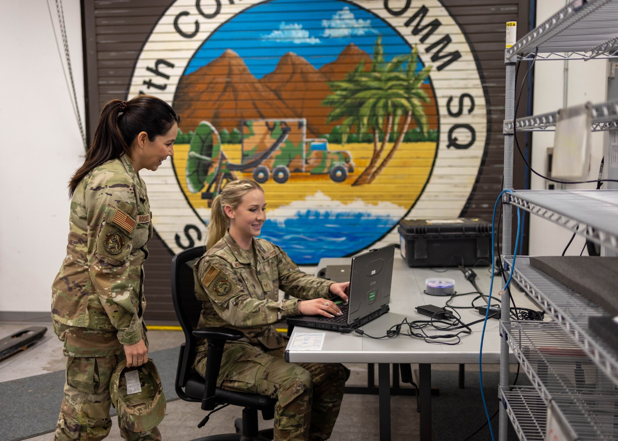 U.S. Air Force Senior Master Sgt. Alejandra Rosales, assigned to the 147th Combat Communications Squadron, 195th Wing, California Air National Guard, advises Staff Sgt. Brittany Mohney, 147th CBCS craftsman May 15, 2024, San Diego California. Rosales has been selected as the Air National Guard Senior Non-Commissioned Officer of the Year for 2024. (U.S. Air National Guard photo by Tech Sgt. Darby Arnold)