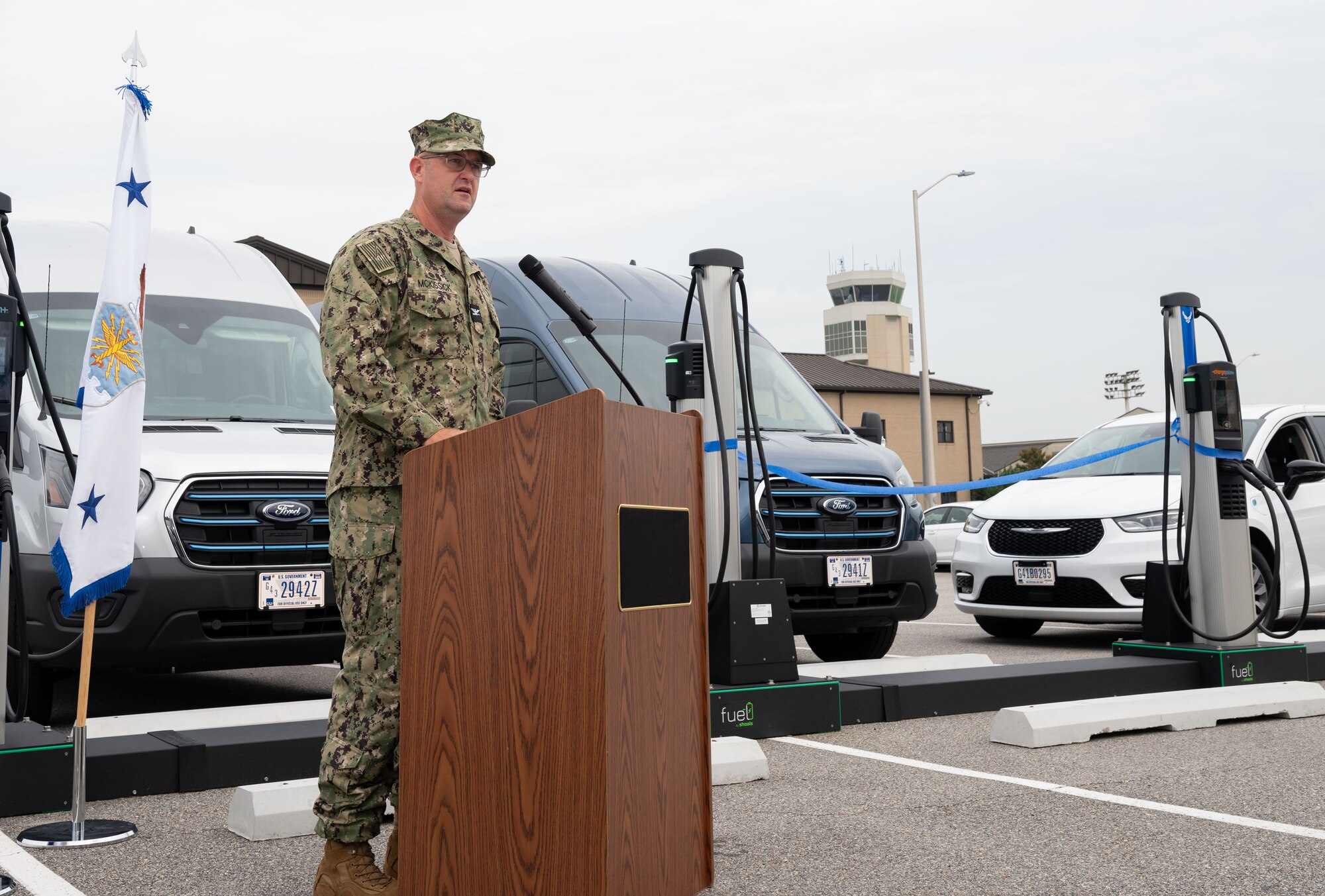 U.S. Navy Capt. Newt McKissick, Energy Portfolio at the Department of Defense Defense Innovation Unit deputy director, provides remarks at a ribbon cutting ceremony for electric vehicle chargers at Dover Air Force Base, Delaware, July 22, 2024. Dover AFB is one of two pilot bases to receive EV government-owned vehicles and the first to construct EV chargers on base – one of the first steps to achieve 100% zero emission vehicles acquisition by 2035 according to executive order 14057. (U.S. Air Force photo by Airman Liberty Matthews)