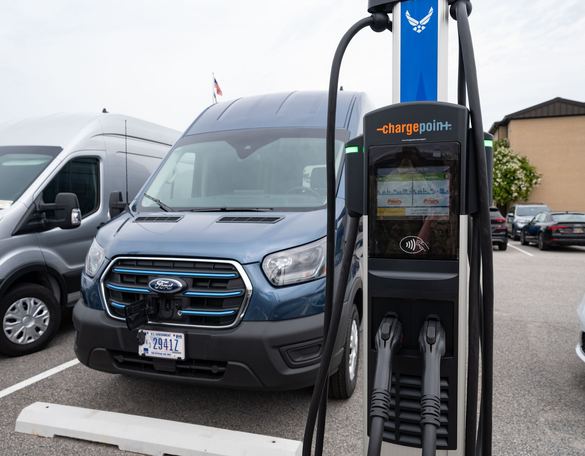 A new electric vehicle charger stands in a parking lot at Dover Air Force Base, Delaware, July 22, 2024. Dover AFB is one of two pilot bases to receive EV government-owned vehicles and the first to construct EV chargers on base – one of the first steps to achieve 100% zero emission vehicles acquisition by 2035 according to executive order 14057. (U.S. Air Force photo by Airman Liberty Matthews)