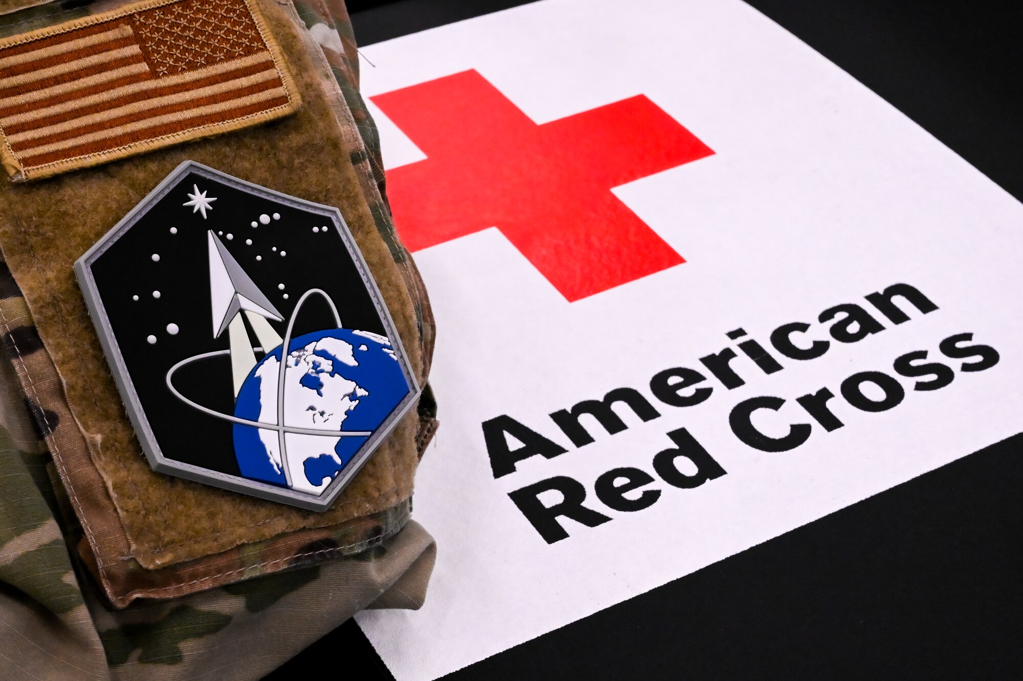 Red Cross and Jacket on table