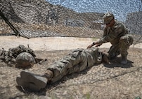 Pvt. Moises Ortega (right) and Spc. Megan King (left), assigned to 369th Chemical Company, 76th Operational Response Command, practiced Combat Life Saving (CLS) techniques on how to evaluate injured Soldiers on the battlefield during the Red Dragon 24 training at Dugway Proving Ground, Utah, on June 14, 2024. The CLS training program empowers Soldiers to act swiftly and effectively in medical emergencies.