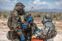 Soldiers assigned to the 76th Operational Response Command realized a pre-entry brief before examining a Chemical, Biological, Radiological, and Nuclear (CBRN) target during the Red Dragon 24 training at Dugway Proving Ground, Utah, June 21, 2024. CBRN Soldiers are responsible for conducting reconnaissance, chemical detection identification, biological agent collection, sampling, decontamination of personnel, equipment, casualties, and individual protective measures in first aid for unit personnel.