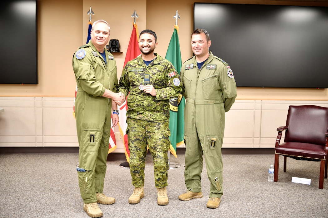 General presenting awards to an Airman