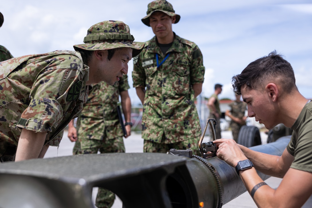 U.S. Marine Corps Lance Cpl. Gael Ornelas, an optics technician with Combat Logistics Battalion 31, 31st Marine Expeditionary Unit demonstrates barrel alignment procedures to Japanese soldiers with the Amphibious Rapid Deployment Brigade, Japanese Ground Self-Defense Force during their visit on Camp Hansen, Okinawa, Japan, July 11, 2024.CLB-31 hosted the ARDB to foster mutual understanding and improving interoperability between the two forces by sharing a wide range of capabilities and practices. The 31st MEU, the Marine Corps’ only continuously forward-deployed MEU, provides a flexible and lethal force, ready to perform a wide range of military operations as the premiere crisis response force in the Indo-Pacific region. (U.S. Marine Corps photo by Cpl. Juan K. Maldonado)