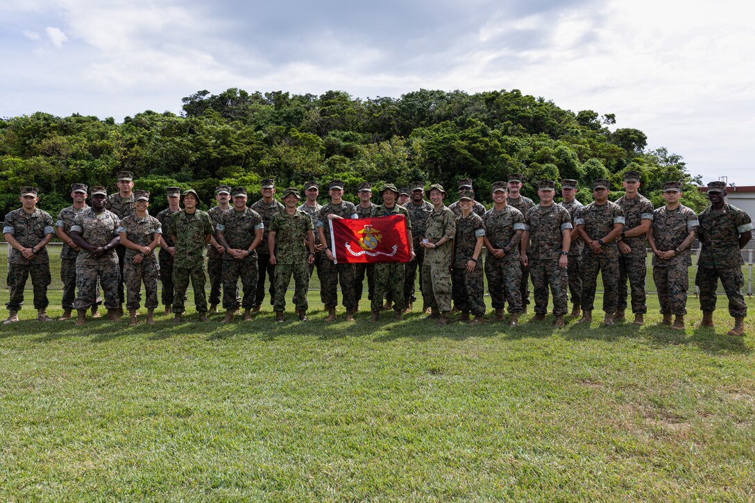 U.S. Marines with Combat Logistics Battalion 31, 31st Marine Expeditionary Unit, and Soldiers with the Amphibious Rapid Deployment Brigade, Japanese Ground Self-Defense Force pose for a photo on Camp Hansen, Okinawa, Japan, July 11, 2024. CLB-31 hosted the ARDB to foster mutual understanding and improving interoperability between the two forces by sharing a wide range of capabilities and practices. The 31st MEU, the Marine Corps’ only continuously forward-deployed MEU, provides a flexible and lethal force, ready to perform a wide range of military operations as the premiere crisis response force in the Indo-Pacific region. (U.S. Marine Corps photo by Cpl. Juan K. Maldonado)