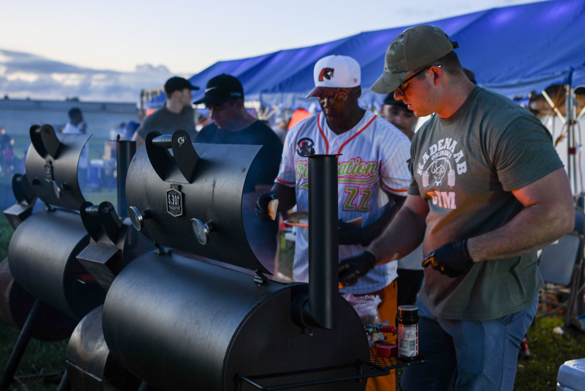 Two U.S. Airmen grill food at Freedom Festival 2024.